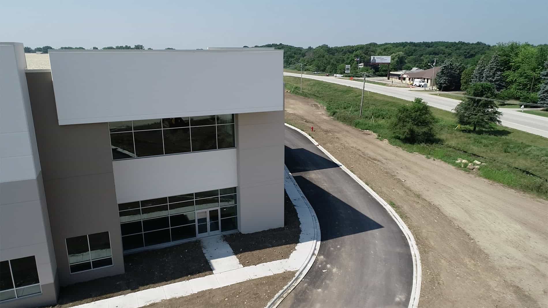 The front entrance to large warehouse and administration building in an industrial park.